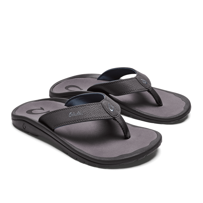 OluKai Ohana sandals with synthetic straps in dark gray and textured footbed, angled side view showing non-marking outsole.