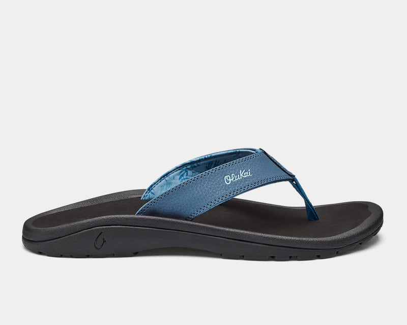 OluKai Ohana sandals in blue with textured straps, black footbed, and durable rubber outsole, side view.