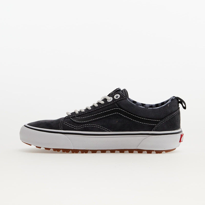 Vans Old Skool MTE sneakers in black suede with white stitching, rugged gum outsole, and pull tab, side view.