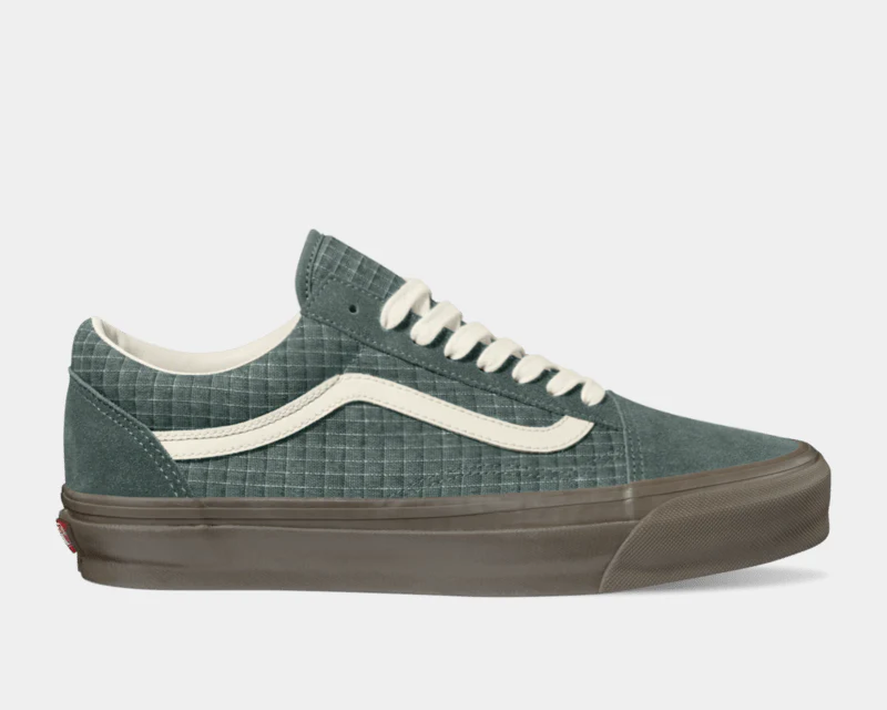 Vans Old Skool MTE shoes in textured green with cream stripe detail and brown sole, side view.