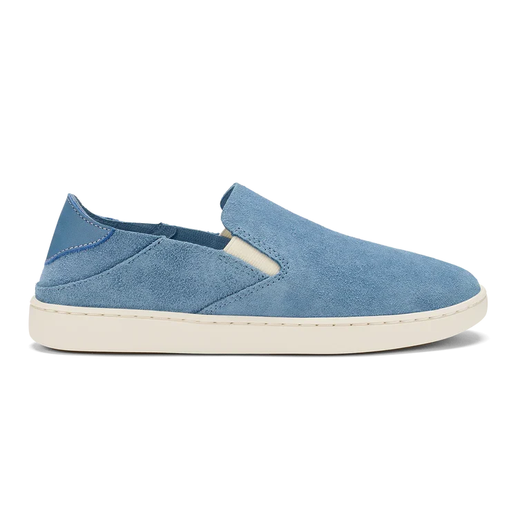 Olukai women’s Pehuea slip-on shoe in blissful blue suede with Drop-In Heel®, elastic side panels, and minimalist island-inspired design for casual barefoot comfort.