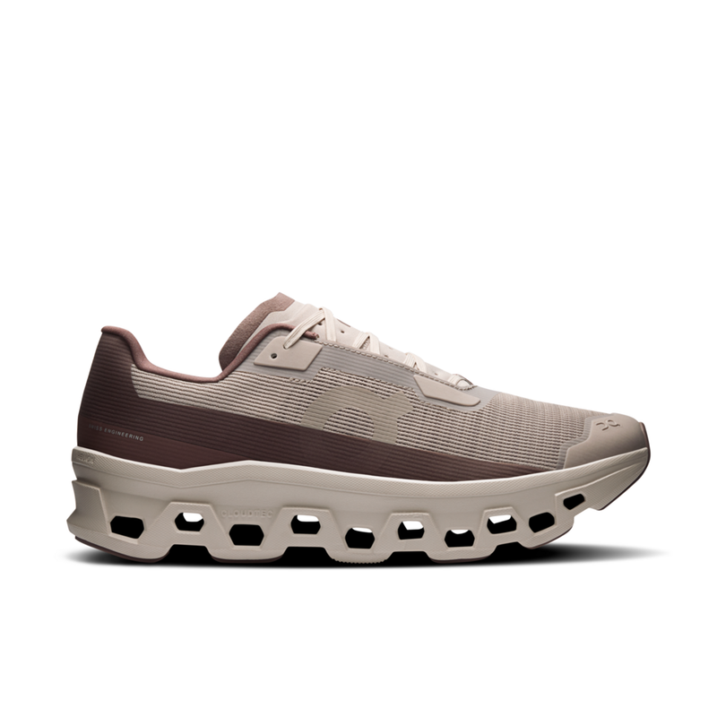Beige running shoe with unique sole design on a white background