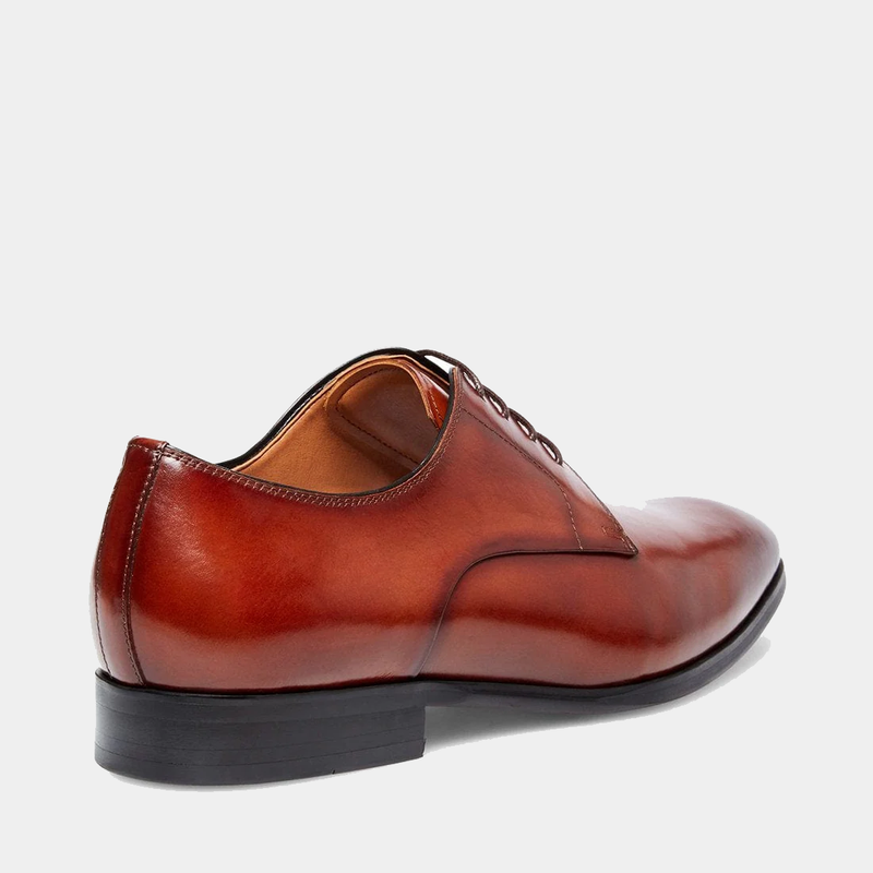 Steve Madden Parsens Leather Oxford shoes in polished brown leather with a sleek design and black stacked heel, side-back view.