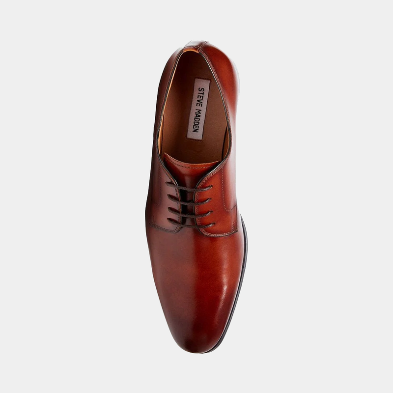 Steve Madden Parsens Leather Oxford shoe in rich brown leather with closed lacing and sleek design, top view.