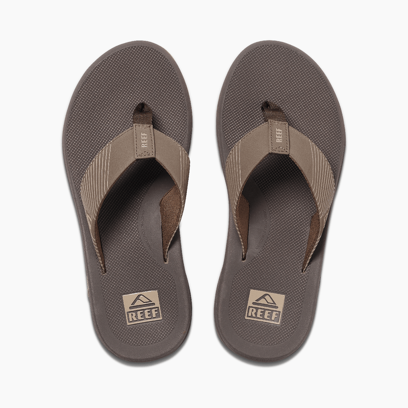 Reef Phantom II flip-flops in brown with textured footbeds and striped fabric straps, top view.
