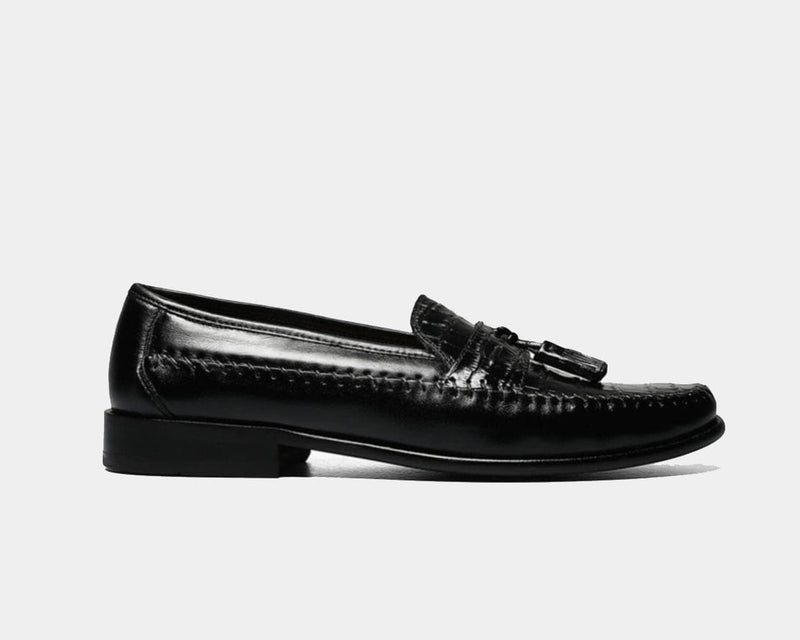 Florsheim Pisa dress loafers in black leather with tassel detailing and stitched accents, side view.