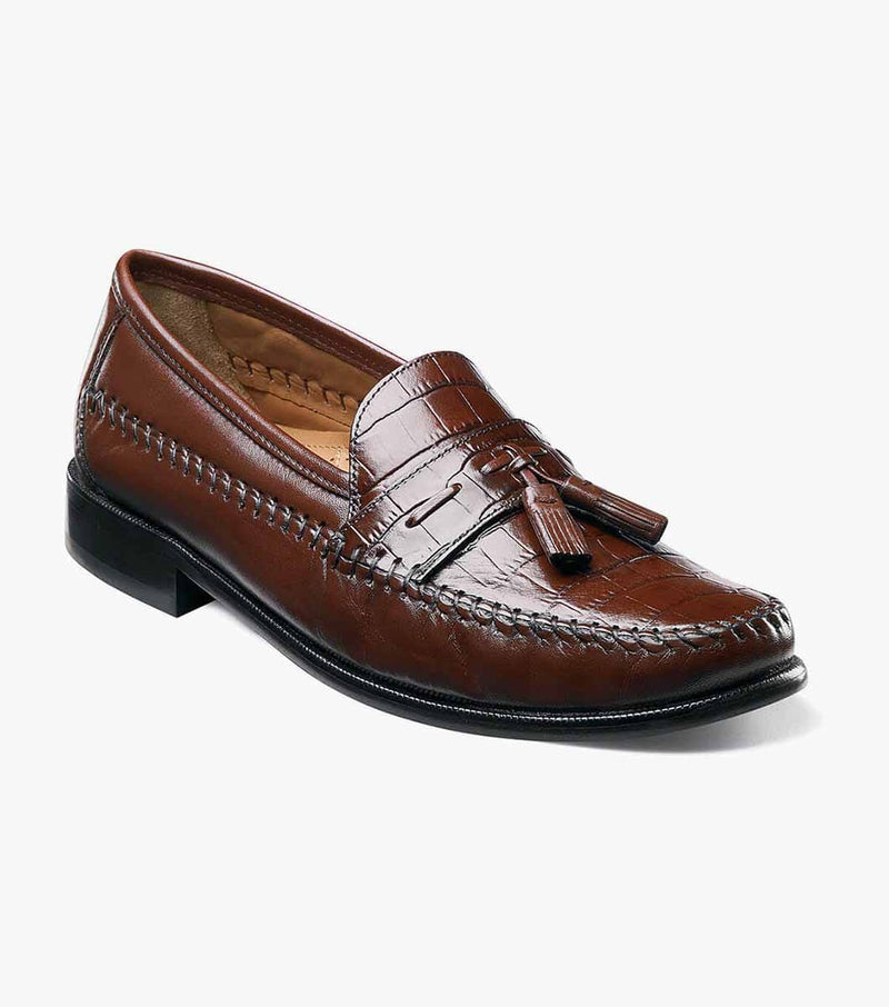 Florsheim Pisa dress loafers in brown leather with tassel detail and stitched accents, angled side view.
