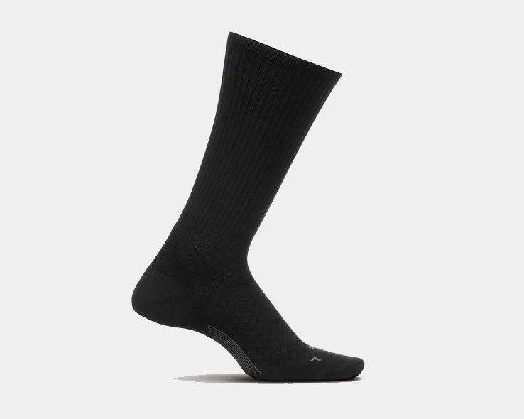 Feetures Plantar Fasciitis Relief Sock Light Cushion Crew socks in solid black with ribbed crew design and targeted compression, side view.