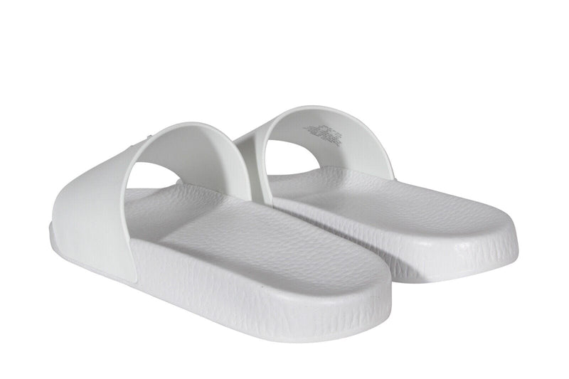 Polo Ralph Lauren Polo Signature Slide sandals in white with textured footbed and wide strap, angled side view.