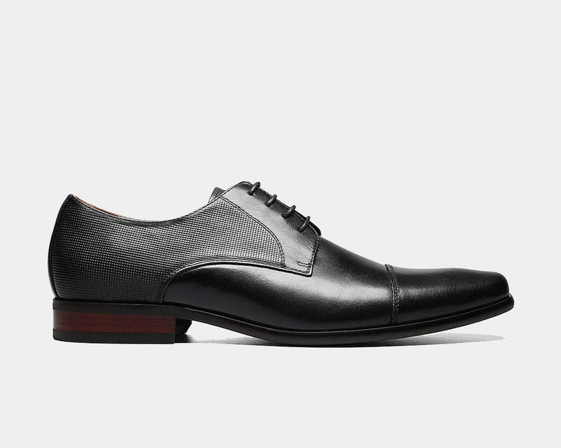 Florsheim Postino Cap Toe Oxford dress shoes in black leather with textured side panels and wooden heel, side view.