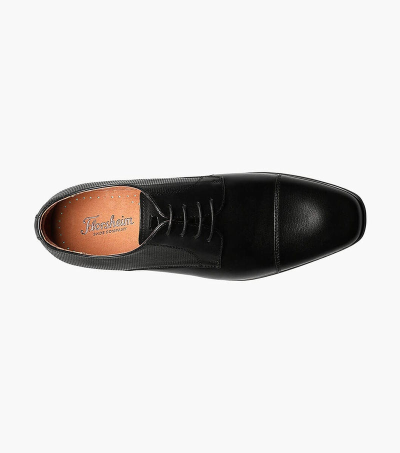 Florsheim Postino Cap Toe Oxford dress shoe in black leather with cap toe detail and lace-up design, top view showing branded tan insole.