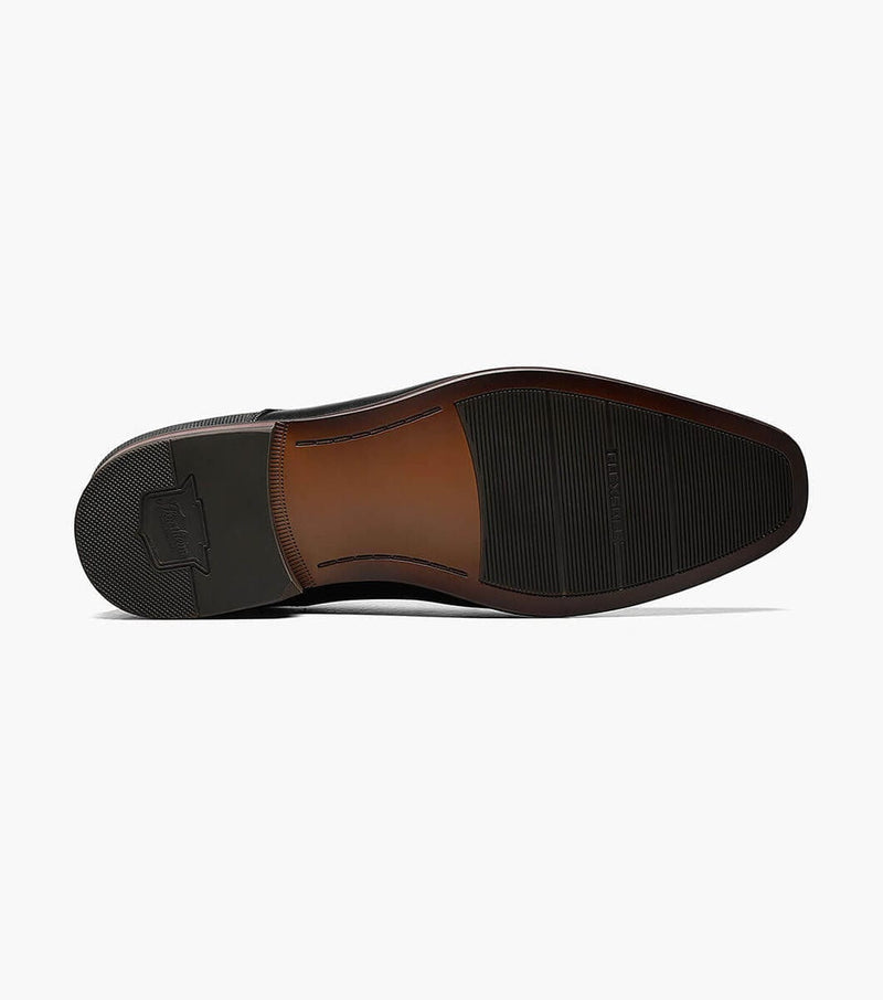 Florsheim Postino Cap Toe Oxford dress shoe outsole with textured black rubber grip and sleek brown finish, bottom view.