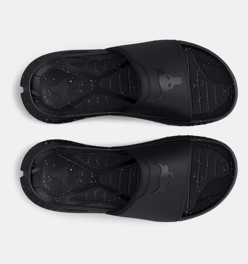 Under Armour Project Rock 3 Slides in black with speckled textured footbed and bold Brahma Bull logo on strap, top view.