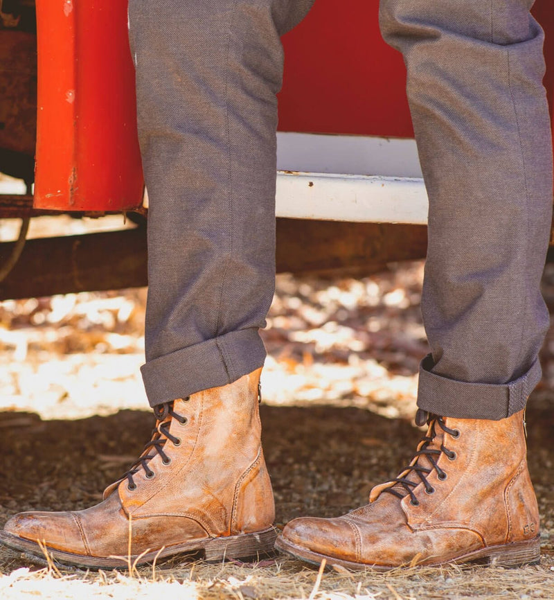 Bed Stu Protege Vintage Finish boots in distressed tan leather with lace-up design, worn outdoors.