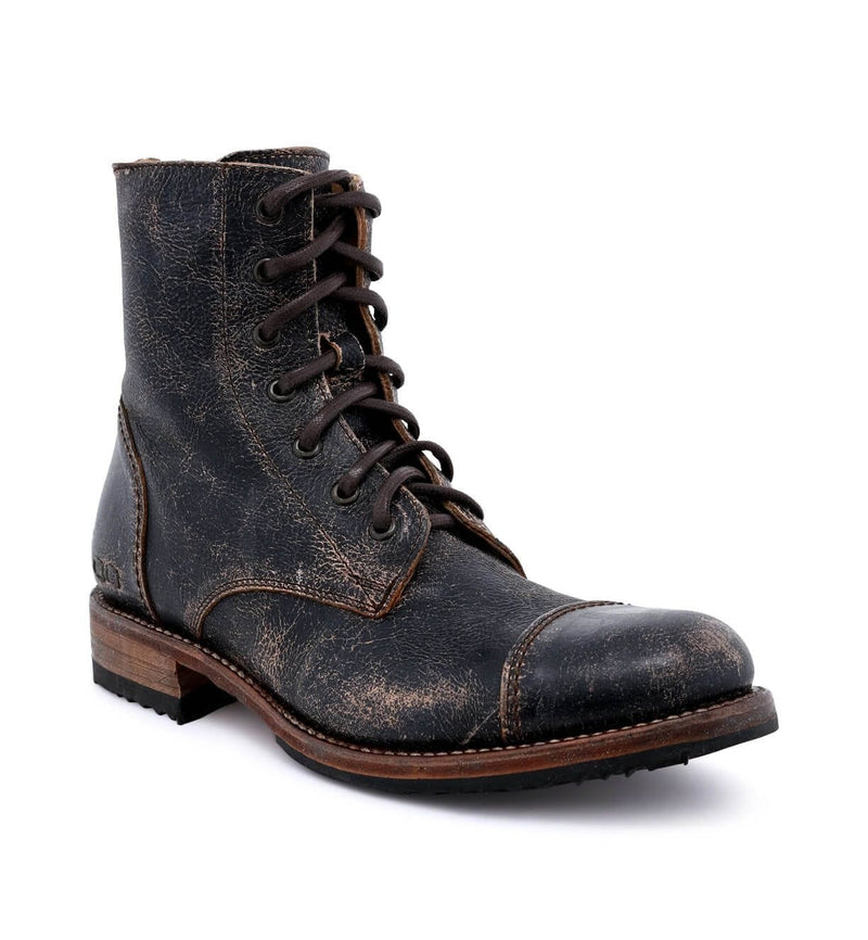 Bed Stu Protege boots in distressed black leather with cap-toe design, lace-up closure, and wooden sole, angled view.