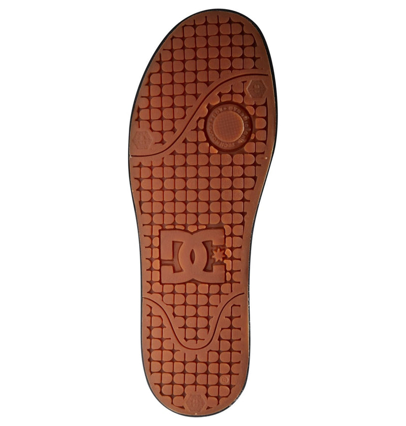 DC Footwear Pure Mid shoe outsole in brown rubber with textured tread design and embossed logo detailing.