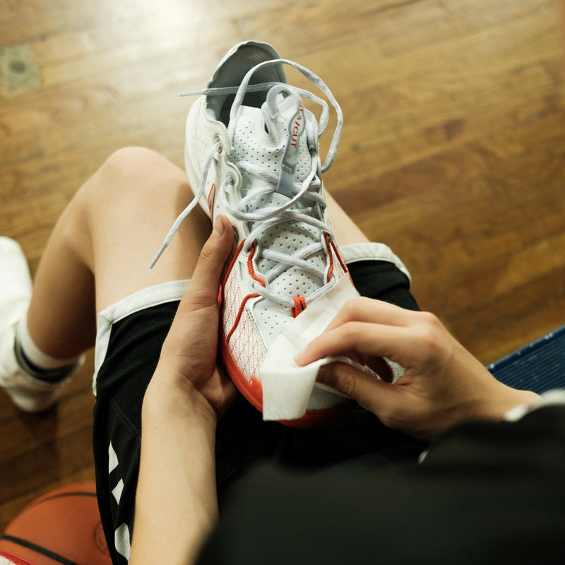 Jason Markk Quick Shoe Cleaning Wipes, demonstrated in use on a white and red sneaker, ideal for on-the-go cleaning