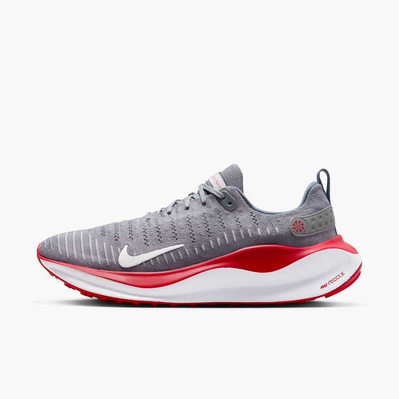 Nike React Infinity Run 4 running shoes in gray with a Flyknit upper, white swoosh, red midsole, and React foam cushioning, side view.