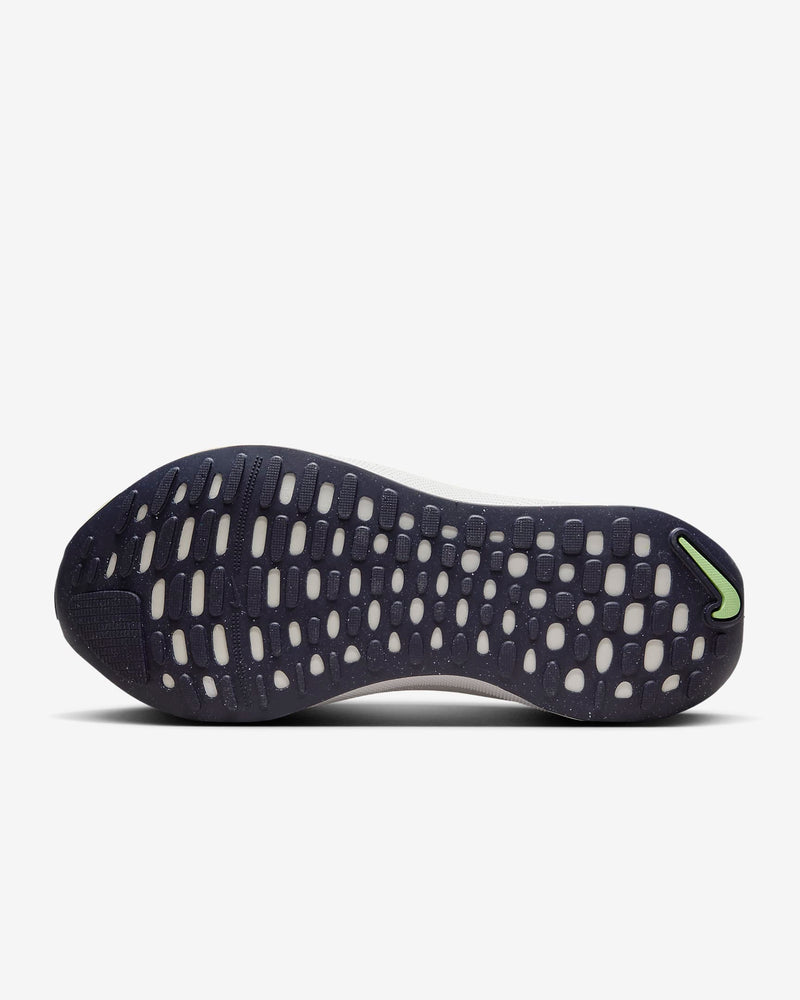 Nike React Infinity Run Flyknit 4 running shoes outsole in navy blue with cushioned design and green accent detailing.