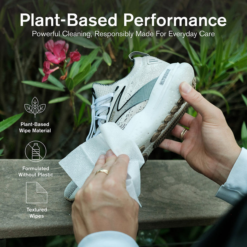 Jason Markk Ready-To-Use Clean Kit with textured plant-based wipes in action cleaning white sneakers, outdoor lifestyle context.