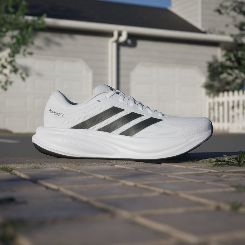 Adidas Response 2 running shoes in white with black stripes and Cloudfoam midsole, side view.
