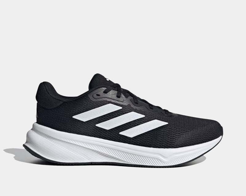 Adidas Response running shoes in black with white three-stripe design, lightweight mesh upper, and cushioned sole, side view.