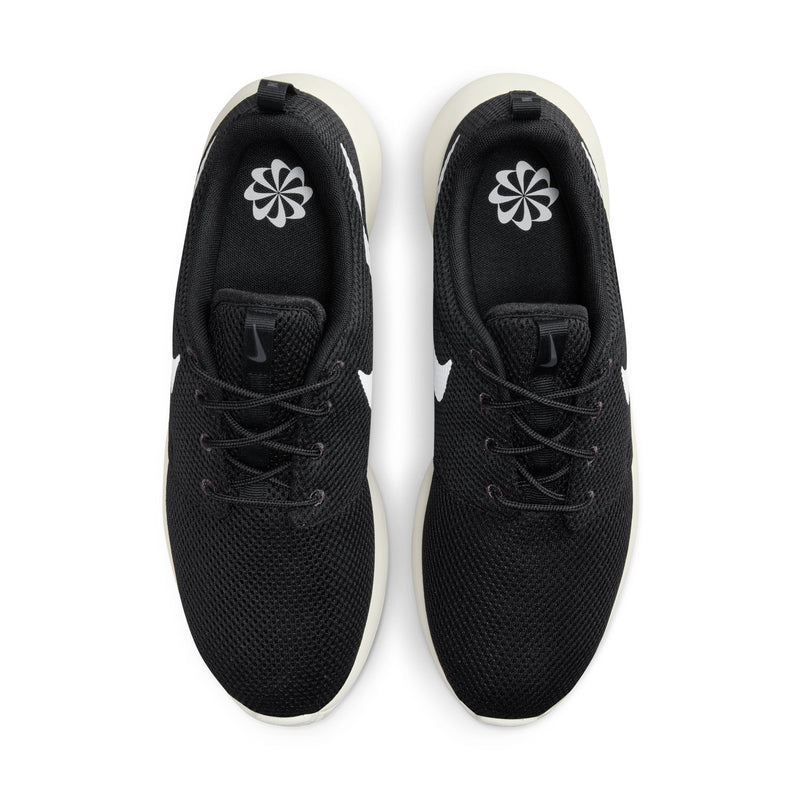 Nike Roshe Golf Next Nature golf shoes in black with mesh upper, white Swoosh logo, and cream outsole, top view.