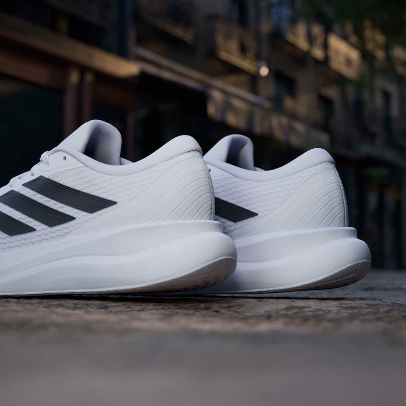 Adidas Runfalcon 6 running shoes in white with black stripes, back view showing heel and outsole design.