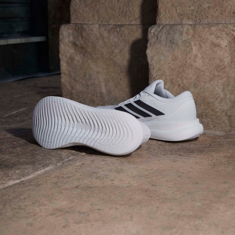 Adidas Runfalcon 6 running shoes in white with black stripes and Adiwear outsole, side and sole view.
