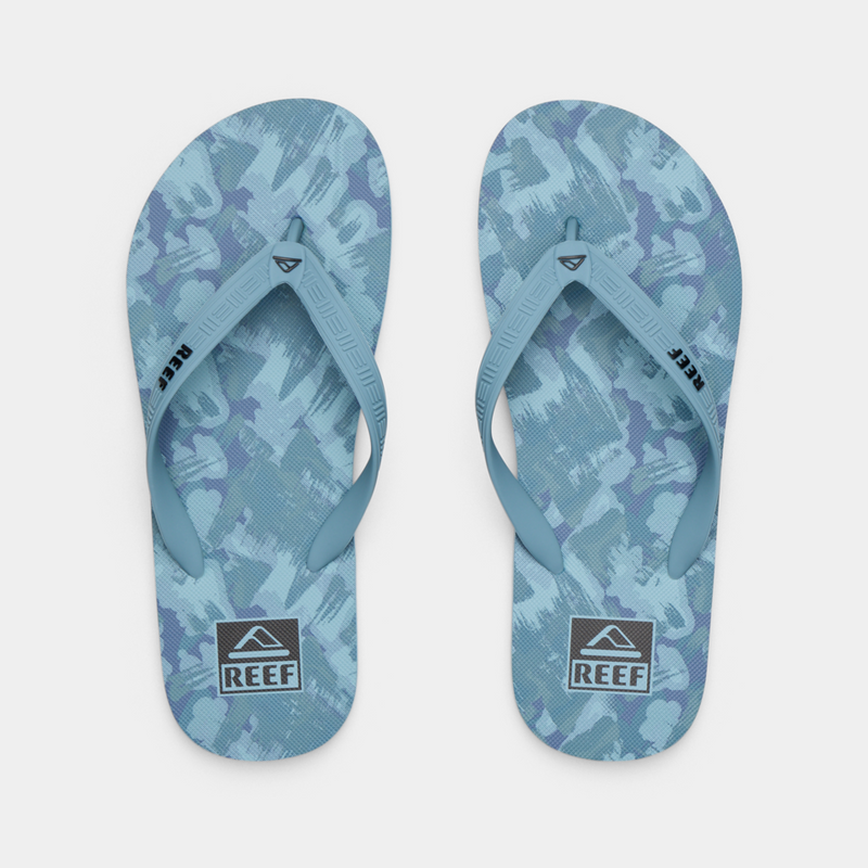 Reef Seaside Prints flip-flops with blue and white abstract pattern, top view showing textured straps.