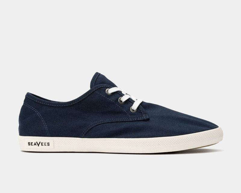SeaVees Sixty Six sneakers in navy canvas with white laces and off-white rubber sole, side view.