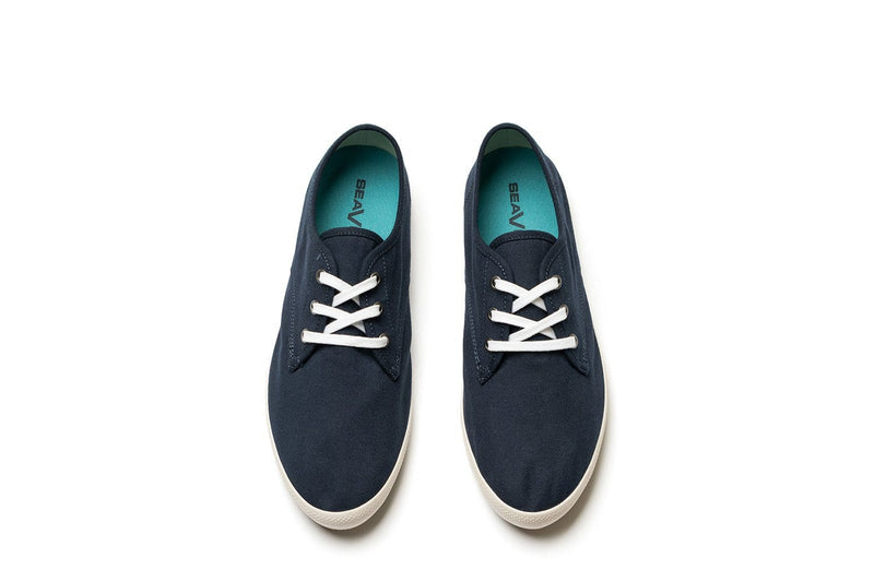 SeaVees Sixty Six sneakers in navy blue canvas with white laces and teal insoles, top view.