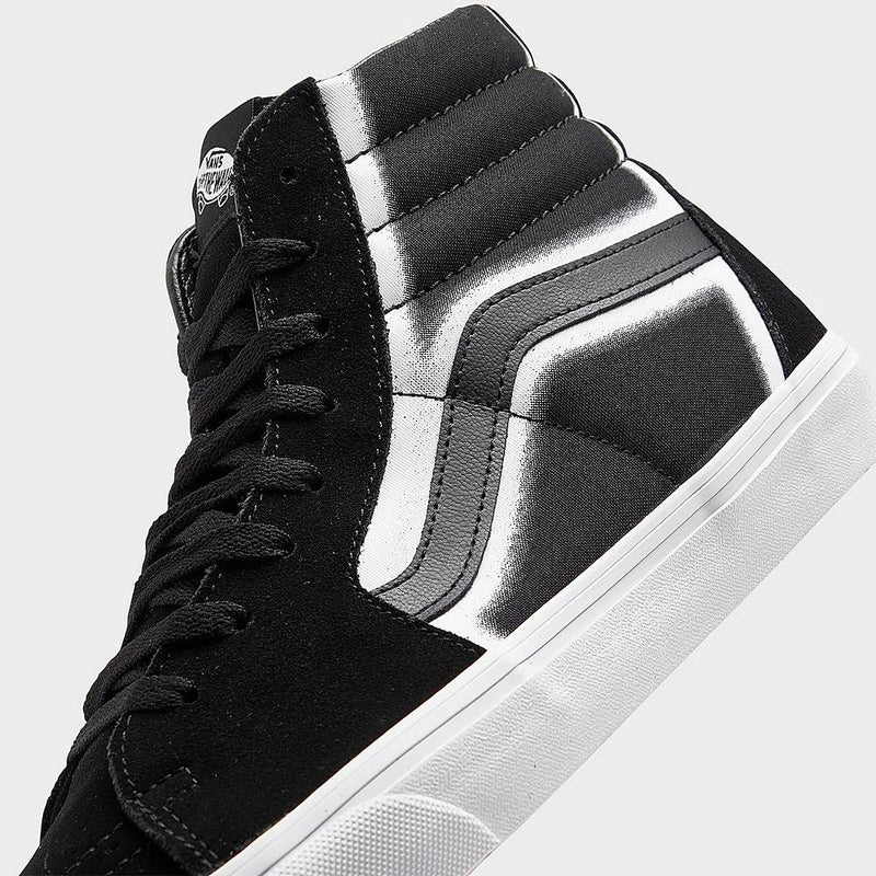 Vans Sk8-Hi high-top sneakers in black and white with side stripe detail and suede upper, close-up side view.