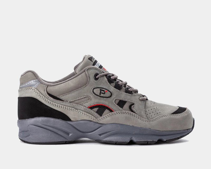 Propét Stability Walker shoes in gray with suede upper, black accents, and breathable perforations, side view.