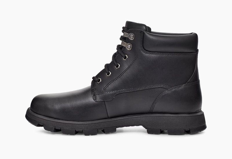 UGG Stenton boots in black leather with padded collar and rugged outsole, side view.