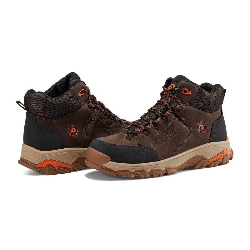 Dunham Stone Safety Toe Work Boot in brown leather and black with orange accents, rugged outsole, angled side view.