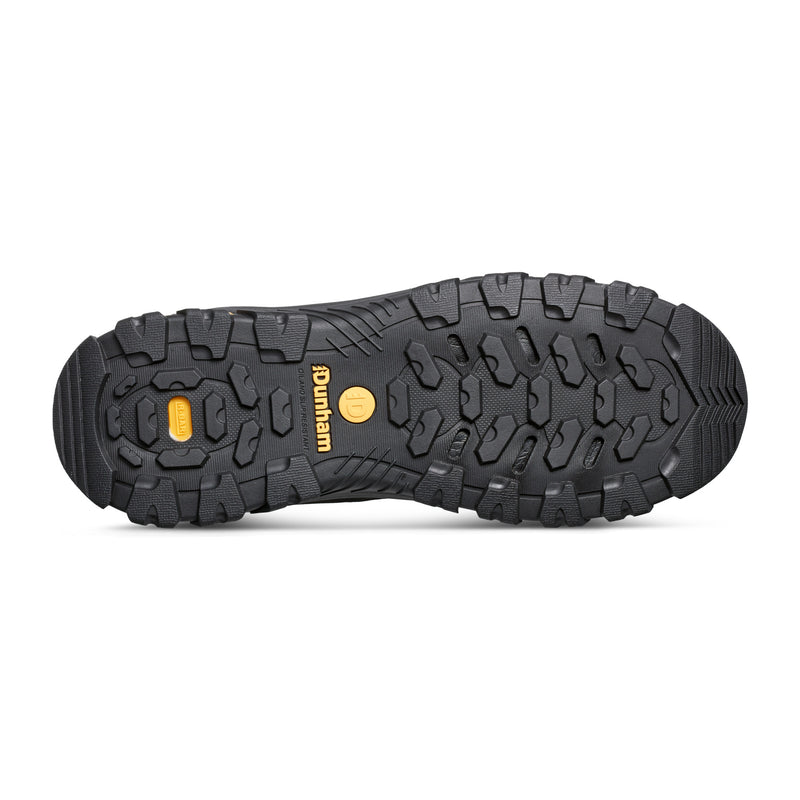 Dunham Stone Safety Toe Work Boot outsole in black rubber with rugged tread pattern and yellow branding, sole/bottom view.