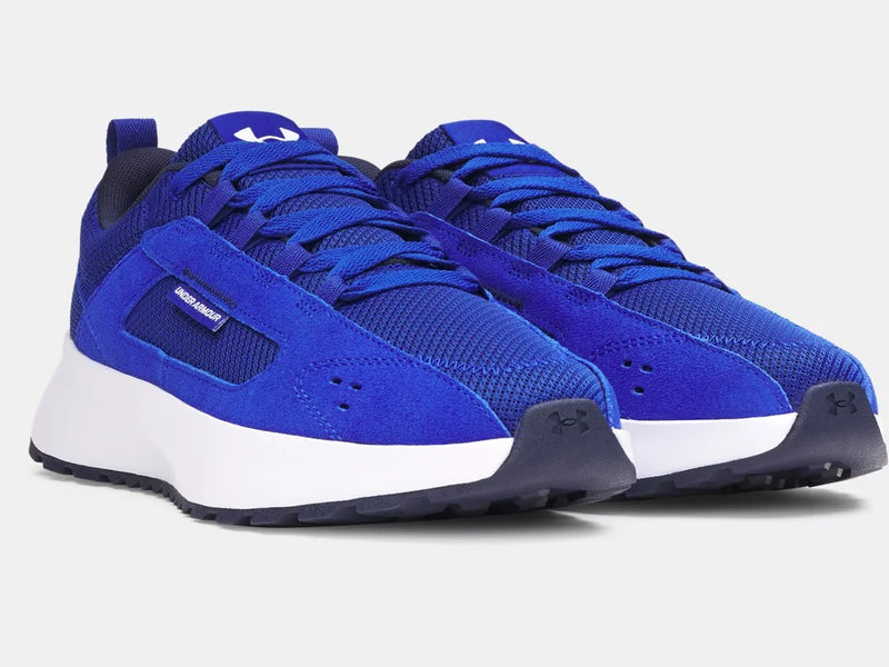 Under Armour Street Mirage sneakers in vibrant royal blue with mesh upper, suede overlays, and white midsole, angled front view.