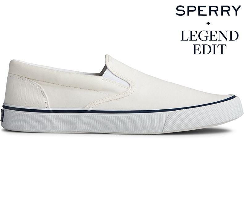 Sperry Striper II Slip On Sneakers in white with canvas upper and white rubber outsole, side view.