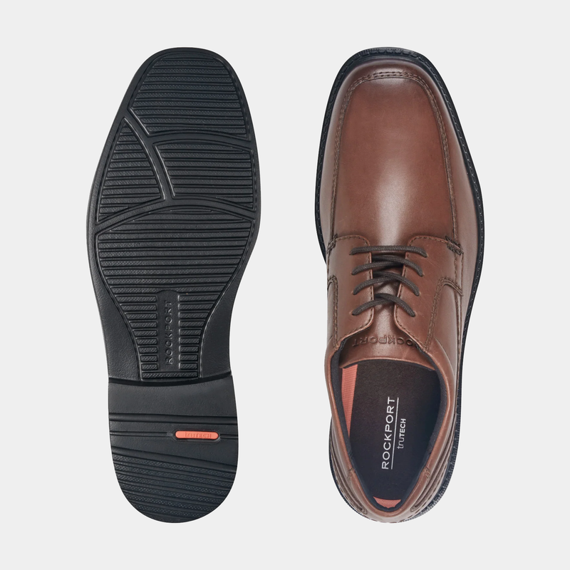 Rockport Style Leader 2 Apron Toe dress shoes in brown leather with cushioned footbed, top and sole views showing slip-resistant outsole.