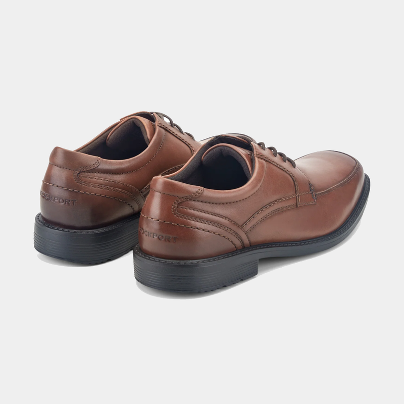 Rockport Style Leader 2 Apron Toe dress shoes in brown leather with stitching details and cushioned black soles, back angle view.