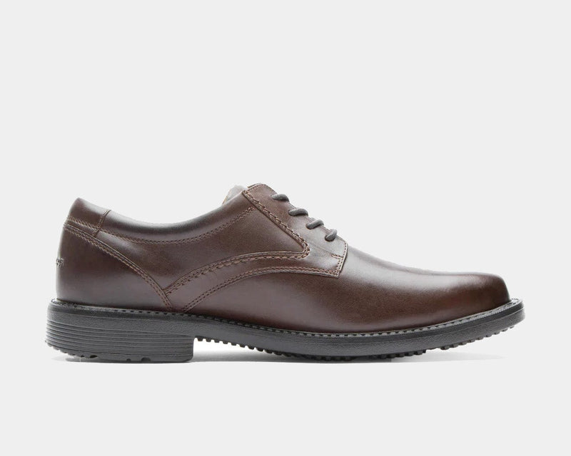 Rockport Style Leader 2 Plain Toe dress shoes in brown leather with lace-up closure and textured rubber outsole, side view.