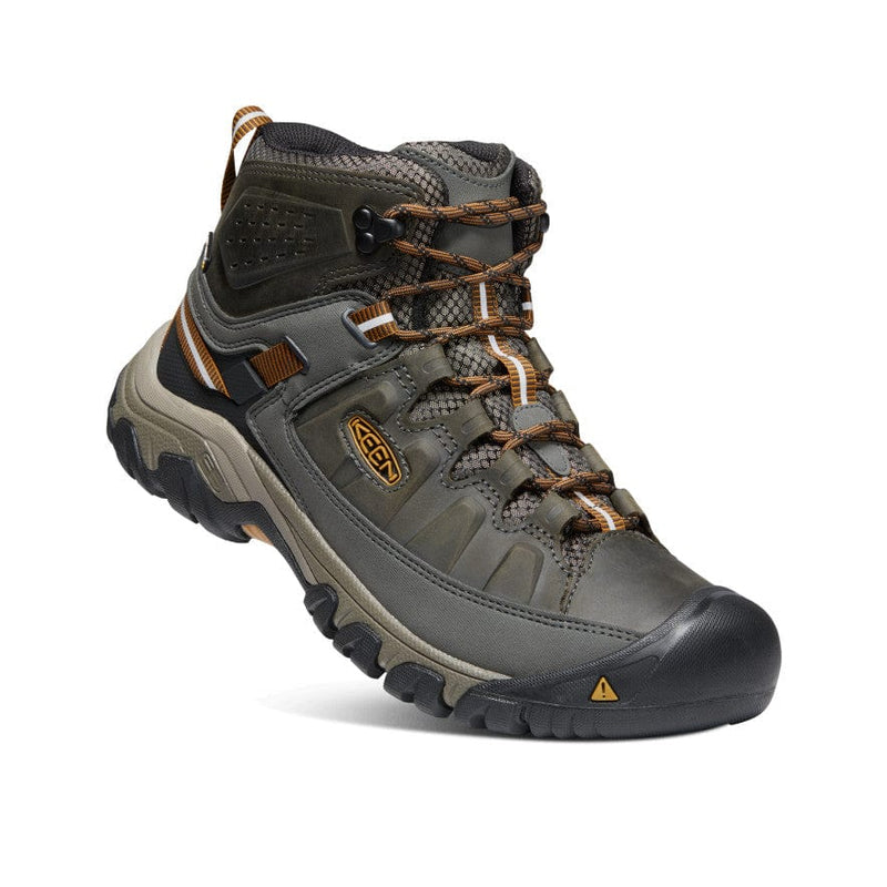 Keen Targhee III Waterproof Mid hiking boots in dark olive and black with leather upper and rugged outsole, angled side view.