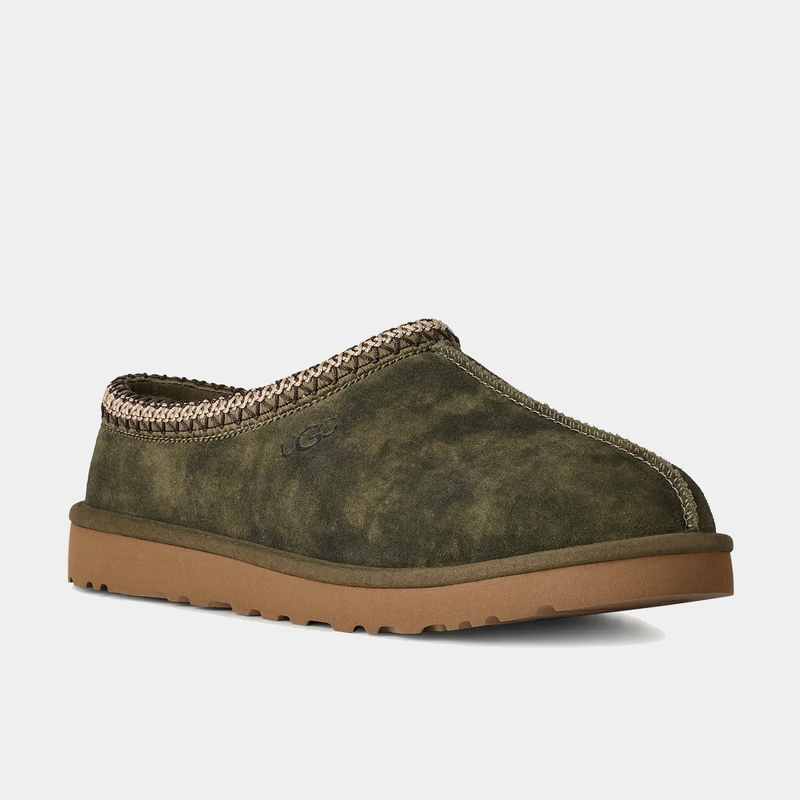 UGG Tasman Baxter slippers in olive green suede with braided trim and cushioned brown sole, side angle view.