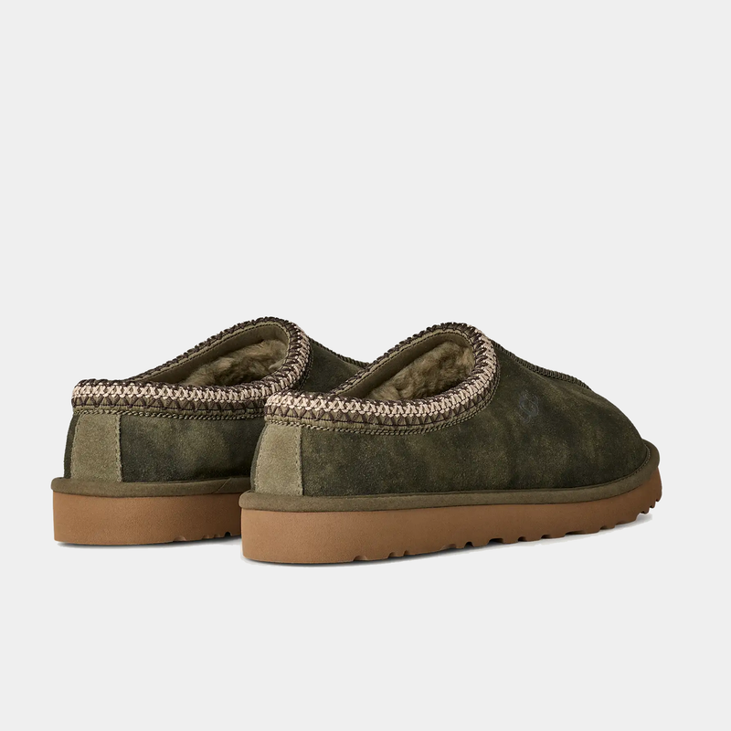 UGG Tasman Baxter slippers in olive green suede with braided trim and soft shearling lining, back angle view.
