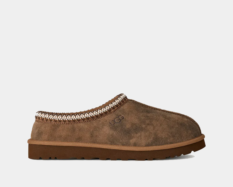 UGG Tasman Baxter slippers in chestnut brown suede with embroidered trim and durable rubber outsole, side view.