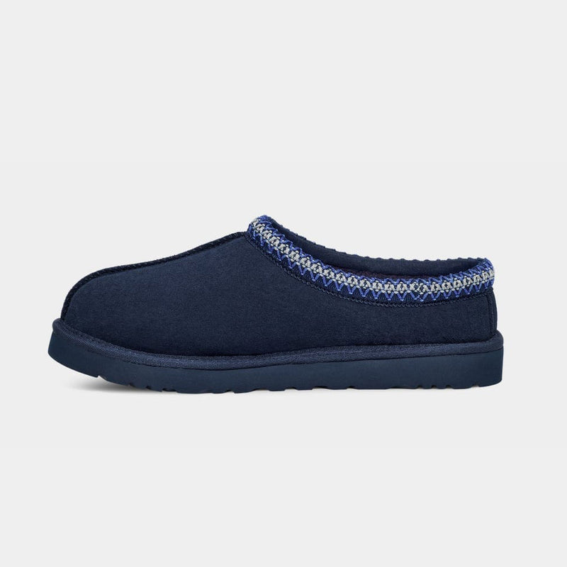 UGG Tasman Slipper in navy blue with suede upper, embroidered detailing on the collar, and lightweight sole, side view.
