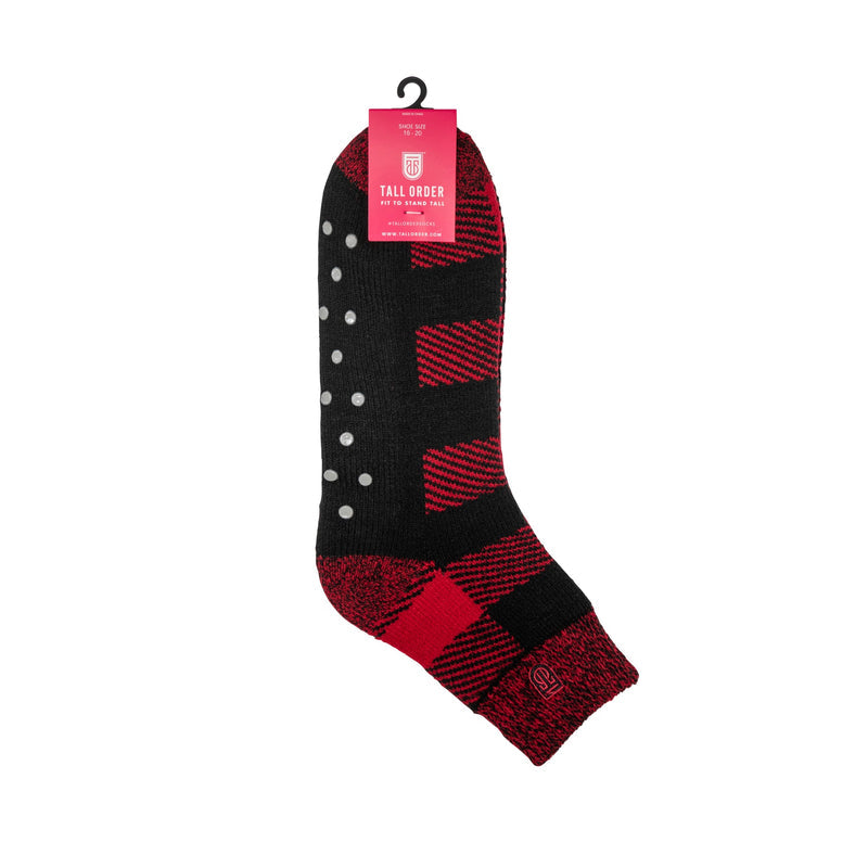 Tall Order The Cabin Slipper Socks in black and red with non-slip grip dots and plaid pattern, side view showing design and packaging.