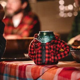 Puffin The Lumberjack drink holder resembling a red and black plaid flannel jacket with zippered front, table setting.