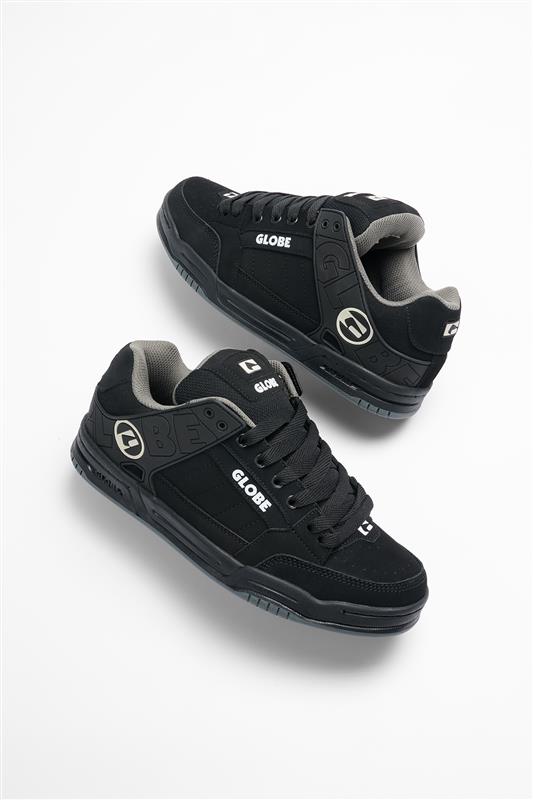 Pair of Tilt skate shoes in black with gray lining viewed from above showing laces and branding.